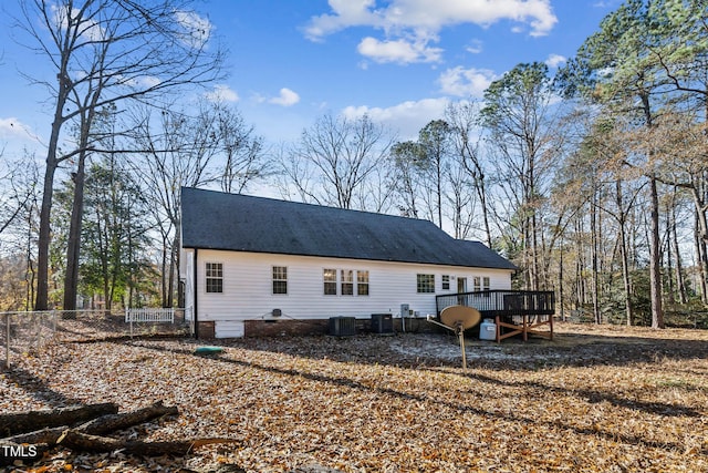 rear view of property with central air condition unit and a wooden deck