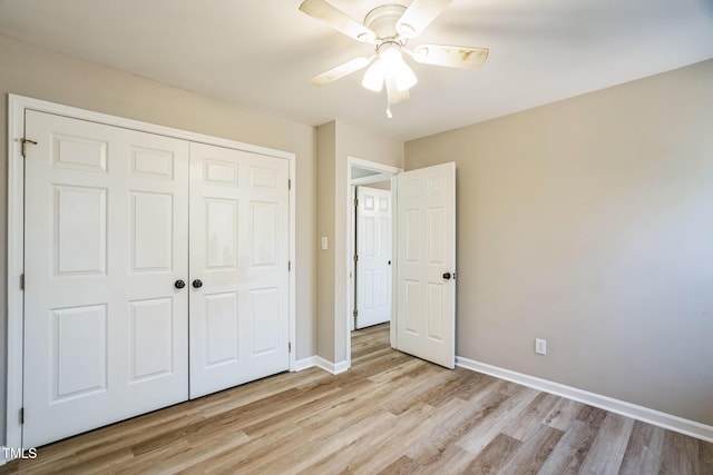 unfurnished bedroom featuring ceiling fan, a closet, and light hardwood / wood-style flooring