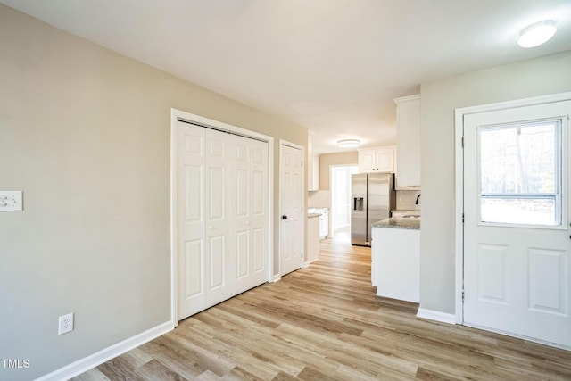 interior space with light hardwood / wood-style flooring and sink