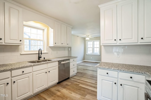 kitchen with white cabinetry, dishwasher, ceiling fan, sink, and light hardwood / wood-style flooring