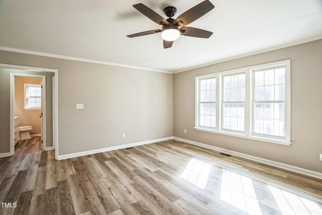 spare room with hardwood / wood-style floors, ceiling fan, and crown molding