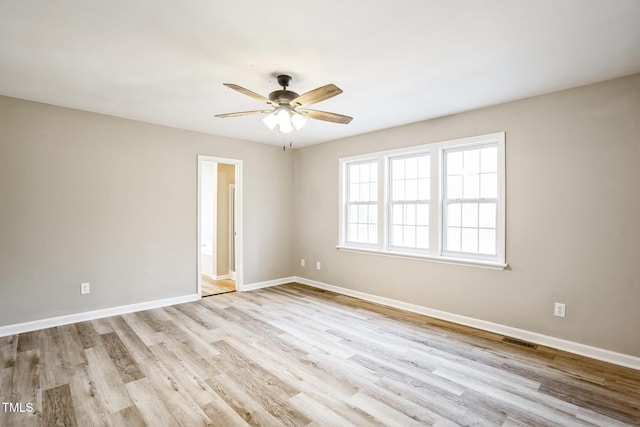 spare room featuring light wood-type flooring and ceiling fan