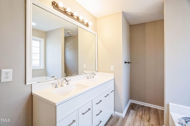 bathroom with hardwood / wood-style flooring and vanity