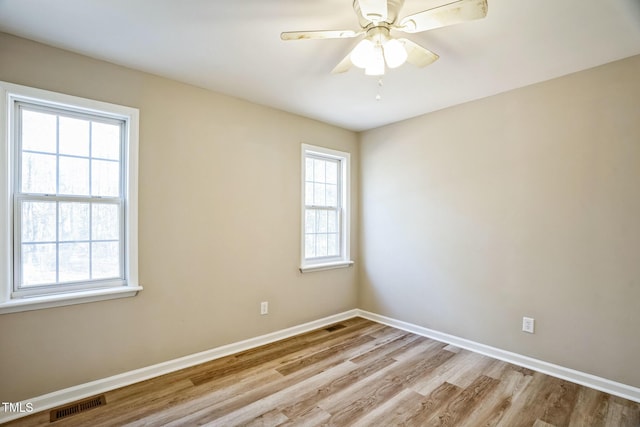 empty room featuring light wood-type flooring and ceiling fan