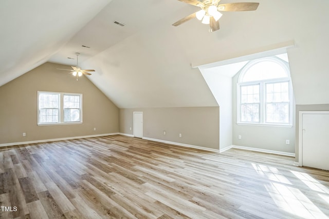 bonus room with ceiling fan, plenty of natural light, light hardwood / wood-style floors, and lofted ceiling