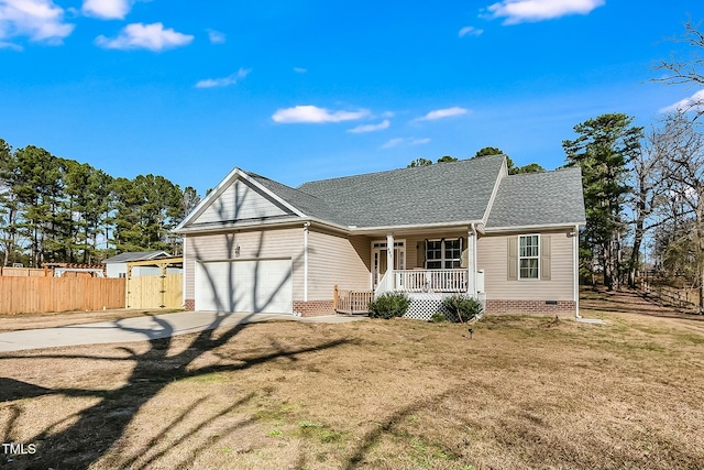 ranch-style home featuring covered porch and a garage