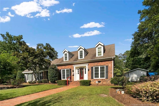 cape cod house featuring a front lawn