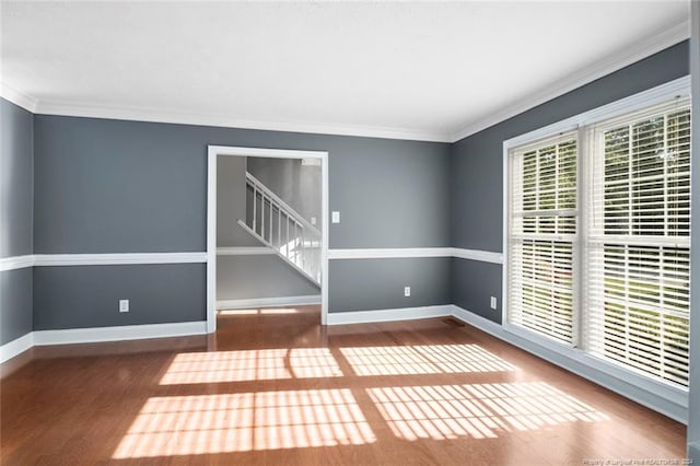 spare room with wood-type flooring and ornamental molding