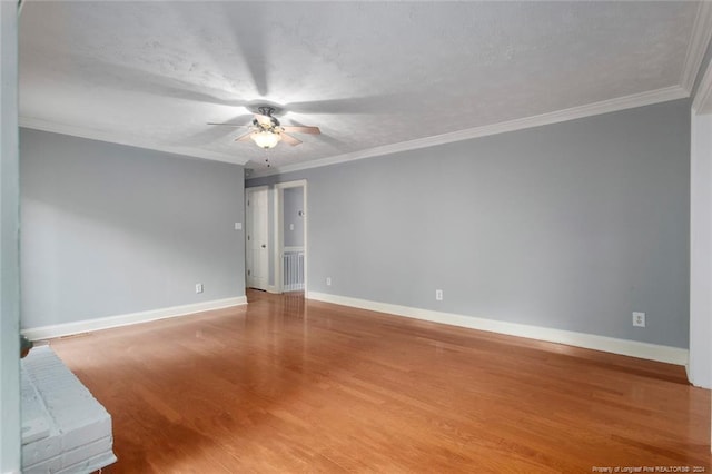 spare room with hardwood / wood-style flooring, ceiling fan, ornamental molding, and a textured ceiling