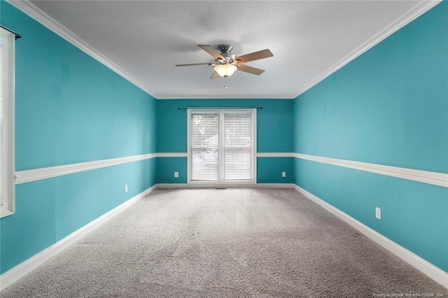 carpeted spare room featuring ceiling fan and ornamental molding