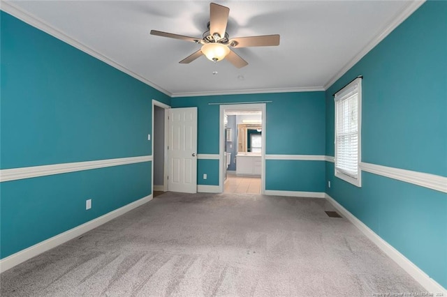 unfurnished bedroom with light carpet, connected bathroom, ceiling fan, and crown molding