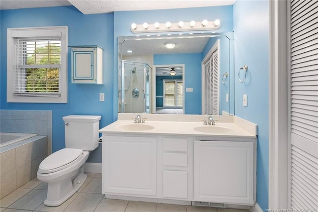 full bathroom featuring vanity, ceiling fan, plus walk in shower, tile patterned flooring, and toilet