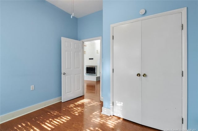 unfurnished bedroom featuring hardwood / wood-style floors and a closet