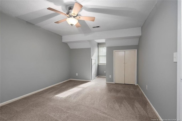 interior space featuring carpet flooring, a textured ceiling, a closet, and ceiling fan