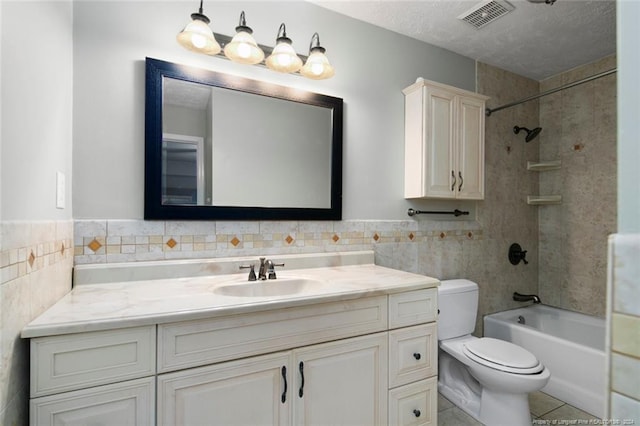 full bathroom featuring vanity, toilet, tile walls, and tiled shower / bath