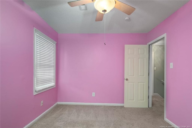 empty room featuring light colored carpet and ceiling fan