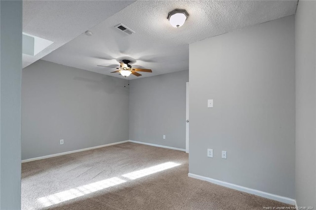 empty room with a textured ceiling, carpet floors, and ceiling fan