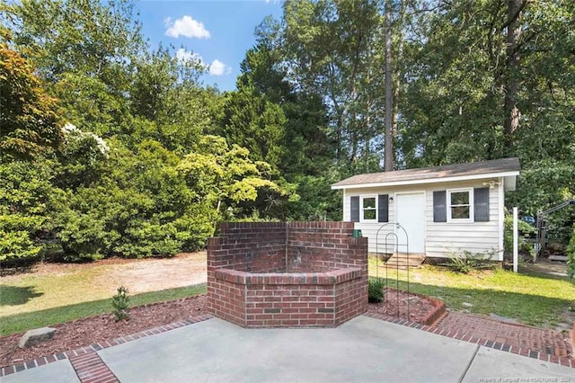 view of patio / terrace featuring an outbuilding