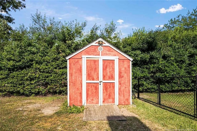 view of outbuilding featuring a lawn