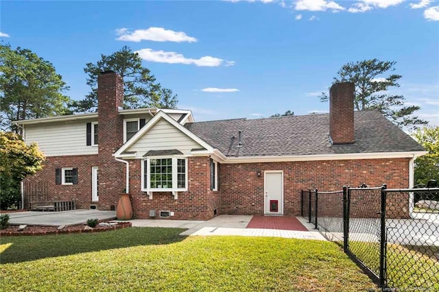 rear view of property featuring a patio area and a lawn