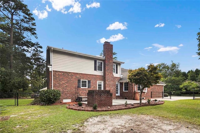 rear view of house featuring a yard and a patio area