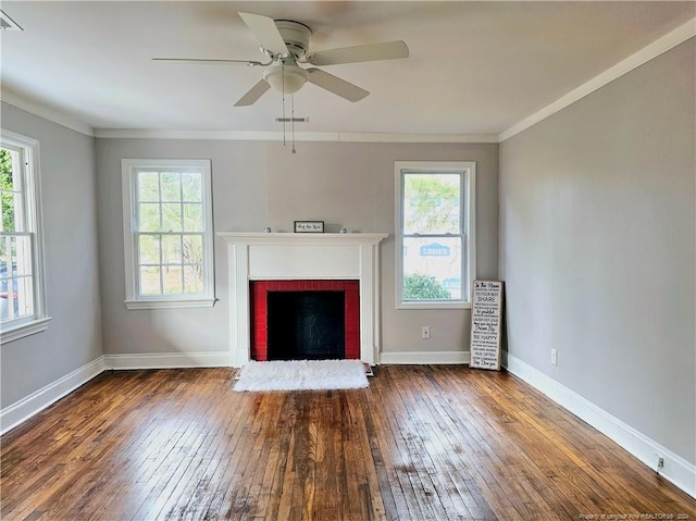 unfurnished living room with a fireplace, wood-type flooring, crown molding, and a healthy amount of sunlight