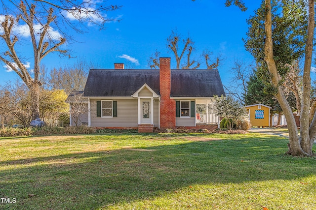 view of front of property with a front lawn and a storage unit