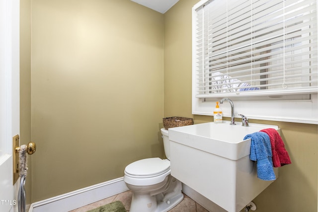 bathroom featuring tile patterned floors, a baseboard heating unit, and toilet