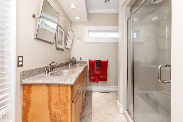 bathroom with crown molding, vanity, a healthy amount of sunlight, and a shower with shower door