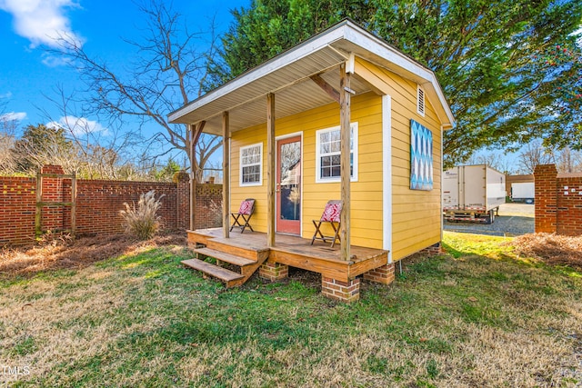 view of outbuilding featuring a lawn