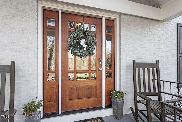 view of exterior entry featuring a porch