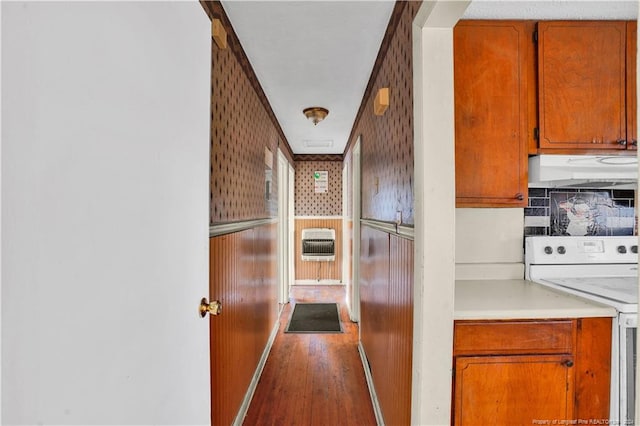 kitchen with backsplash, heating unit, wood-type flooring, and white electric range