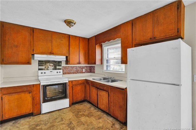 kitchen with backsplash, sink, and white appliances