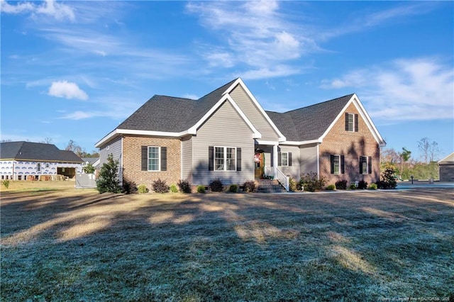 view of front of house with brick siding and a front yard