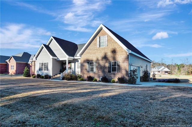 view of front facade featuring brick siding, an attached garage, and a front yard