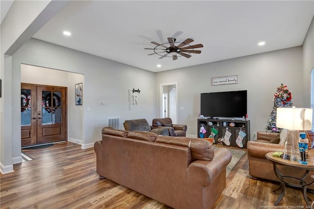 living room featuring recessed lighting, french doors, visible vents, and wood finished floors