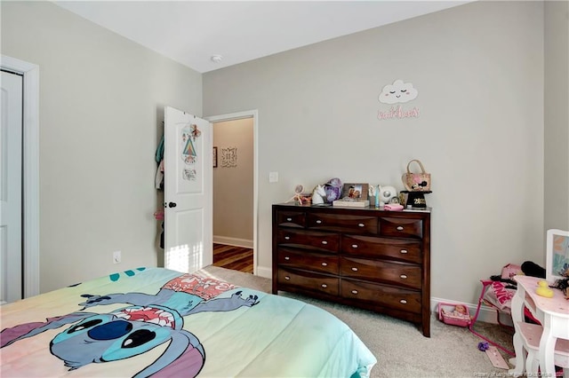 carpeted bedroom featuring baseboards