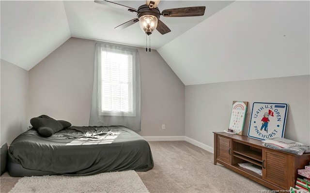 bedroom featuring light carpet, ceiling fan, baseboards, and lofted ceiling