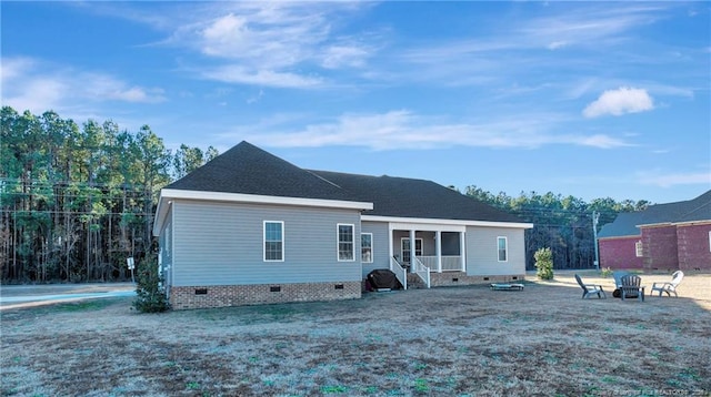 view of front of home featuring crawl space and a fire pit