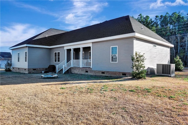 rear view of house featuring covered porch, central AC, crawl space, and a lawn