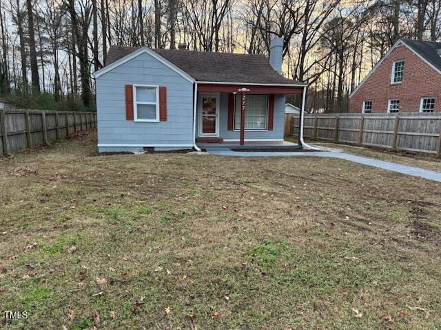 view of front of house with a front yard and a porch