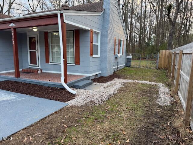 view of side of home with a porch