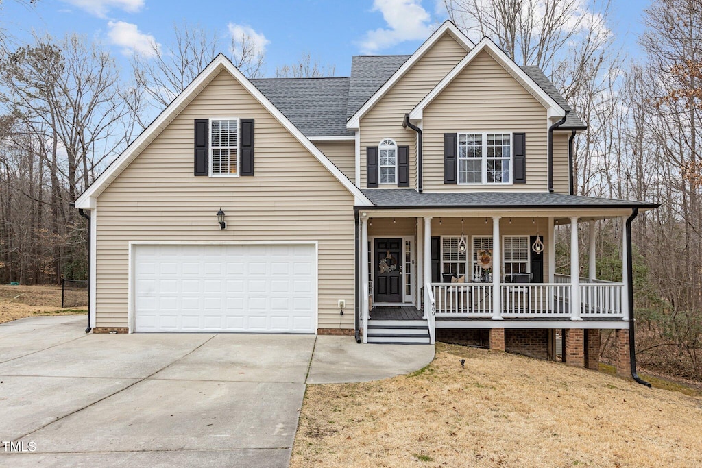 view of front facade with a porch, a garage, and a front yard