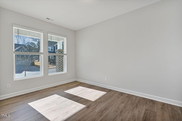 empty room with hardwood / wood-style floors