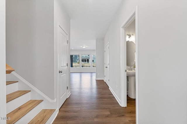 corridor with dark hardwood / wood-style flooring