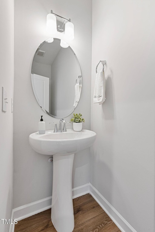 bathroom with hardwood / wood-style flooring and sink