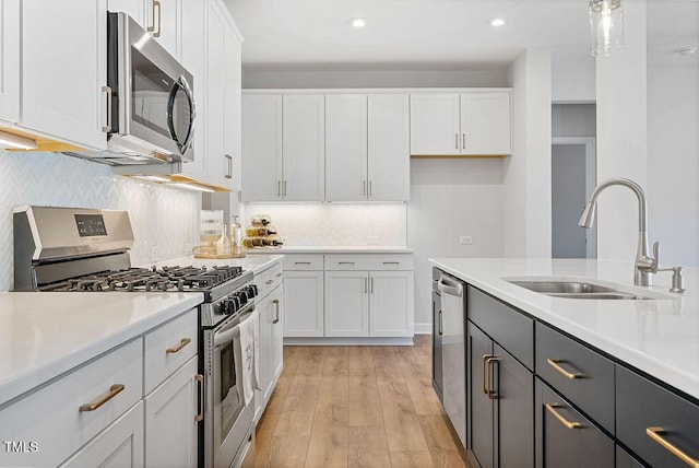 kitchen featuring white cabinetry and appliances with stainless steel finishes