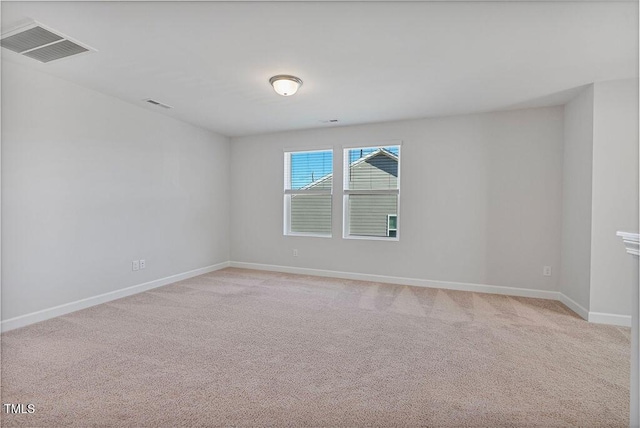 unfurnished room featuring light carpet