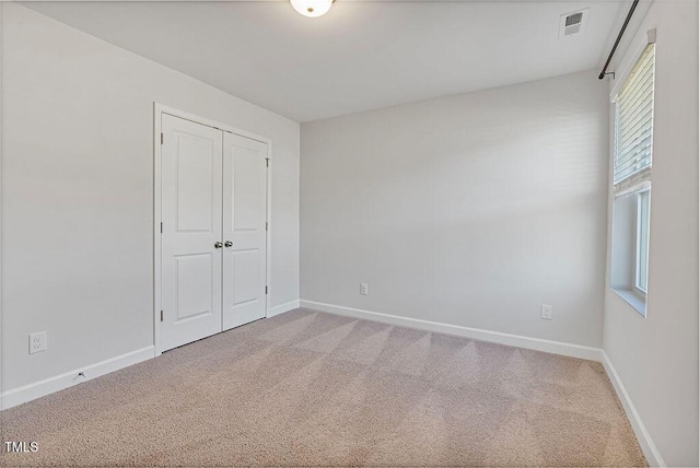 unfurnished bedroom featuring a closet and carpet floors