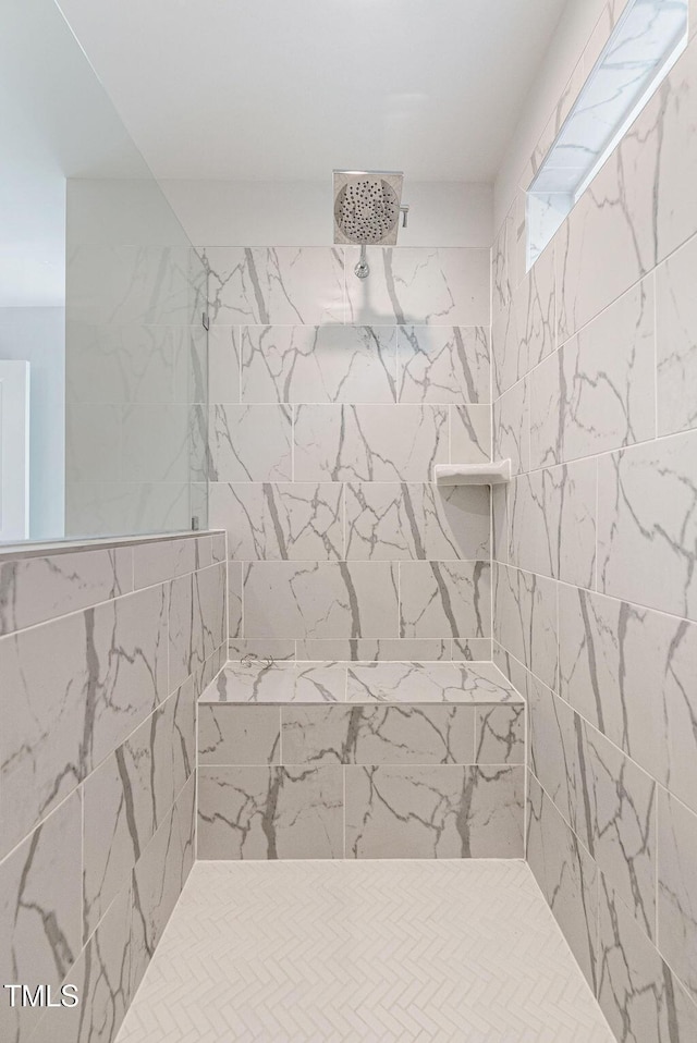 bathroom with a tile shower